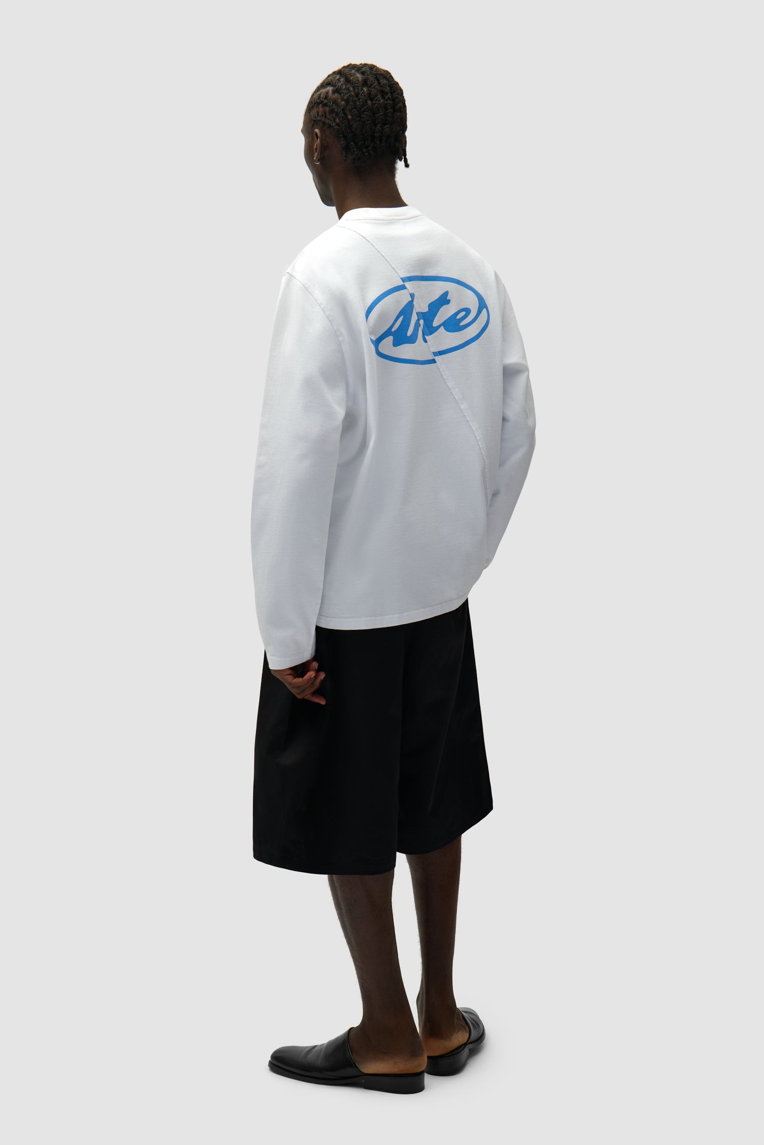 Back Circle Logo Longsleeve in White worn by a model, full-body back view