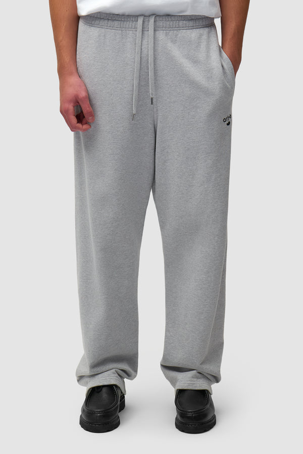 Heart Logo Sweatpants in Grey worn by a model, half-body side view