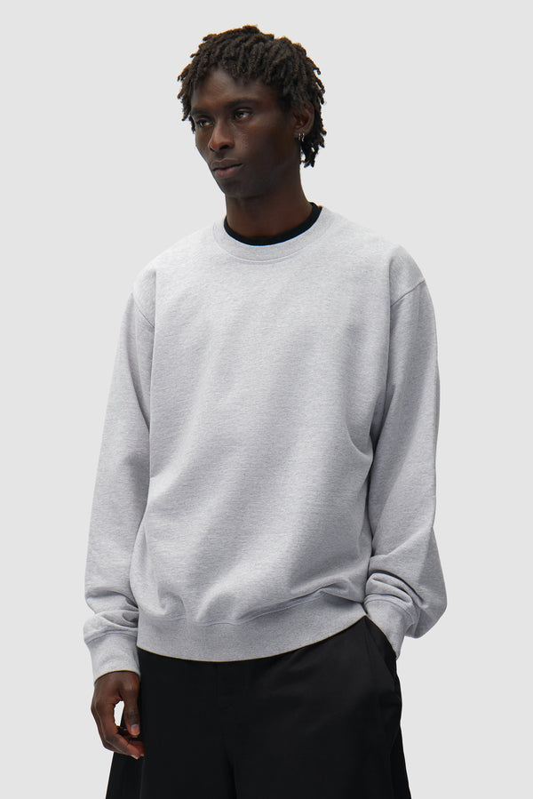 Back SS26 Crewneck in Grey worn by a model, half-body front view