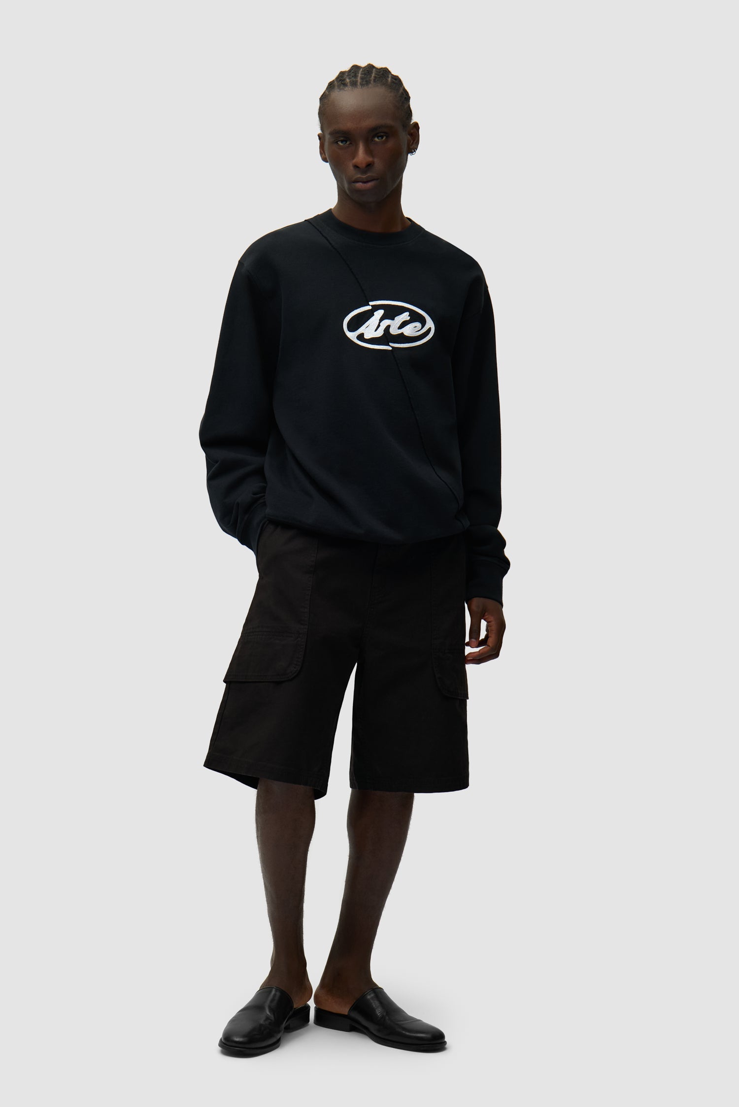 Circle Logo Embroidery Sweater in Black worn by a model, full-body front view