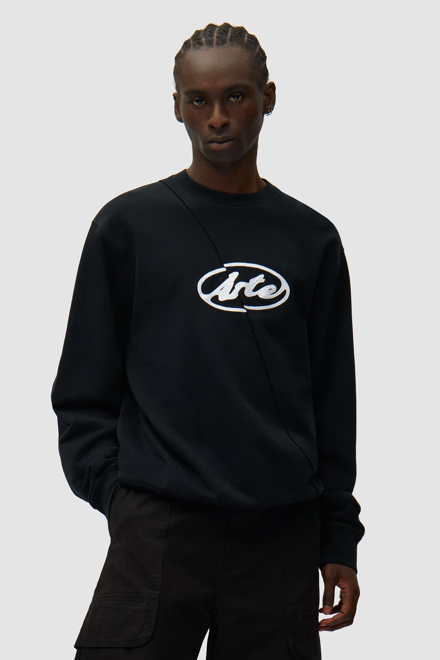 Circle Logo Embroidery Sweater in Black worn by a model, half-body front view