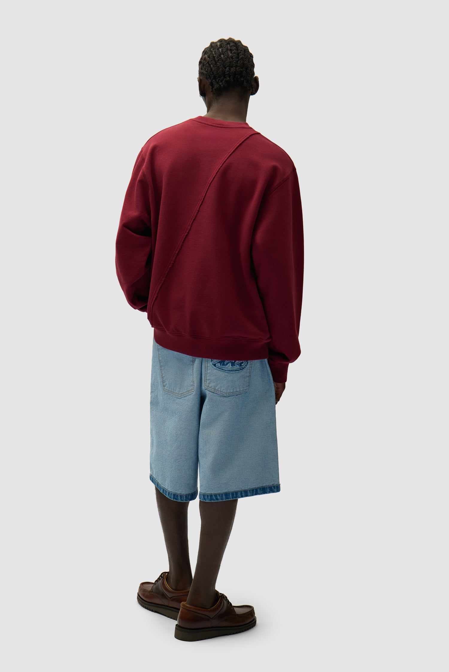Circle Logo Embroidery Sweater in Bordeaux worn by a model, full-body front view