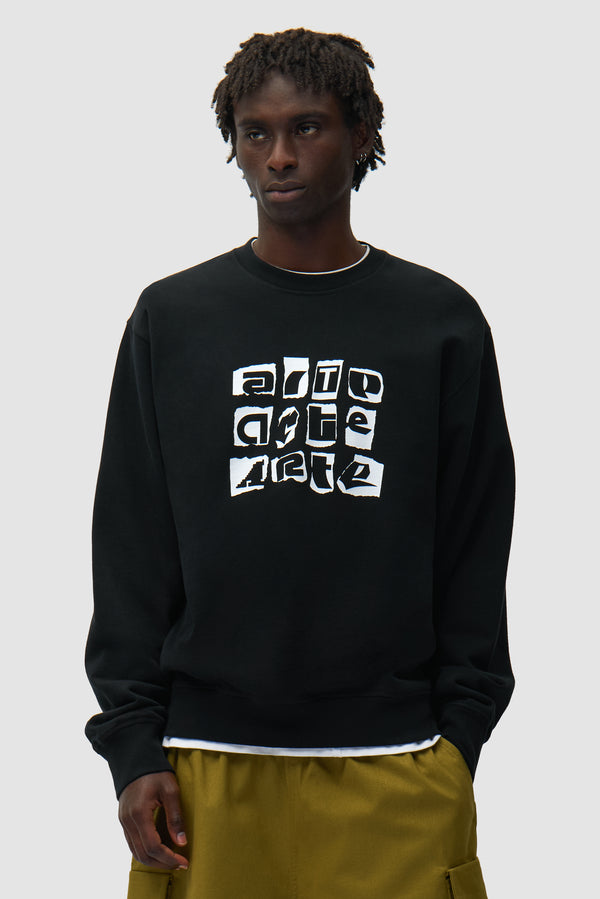 Multi Logo Crewneck in Black worn by a model, half-body front view