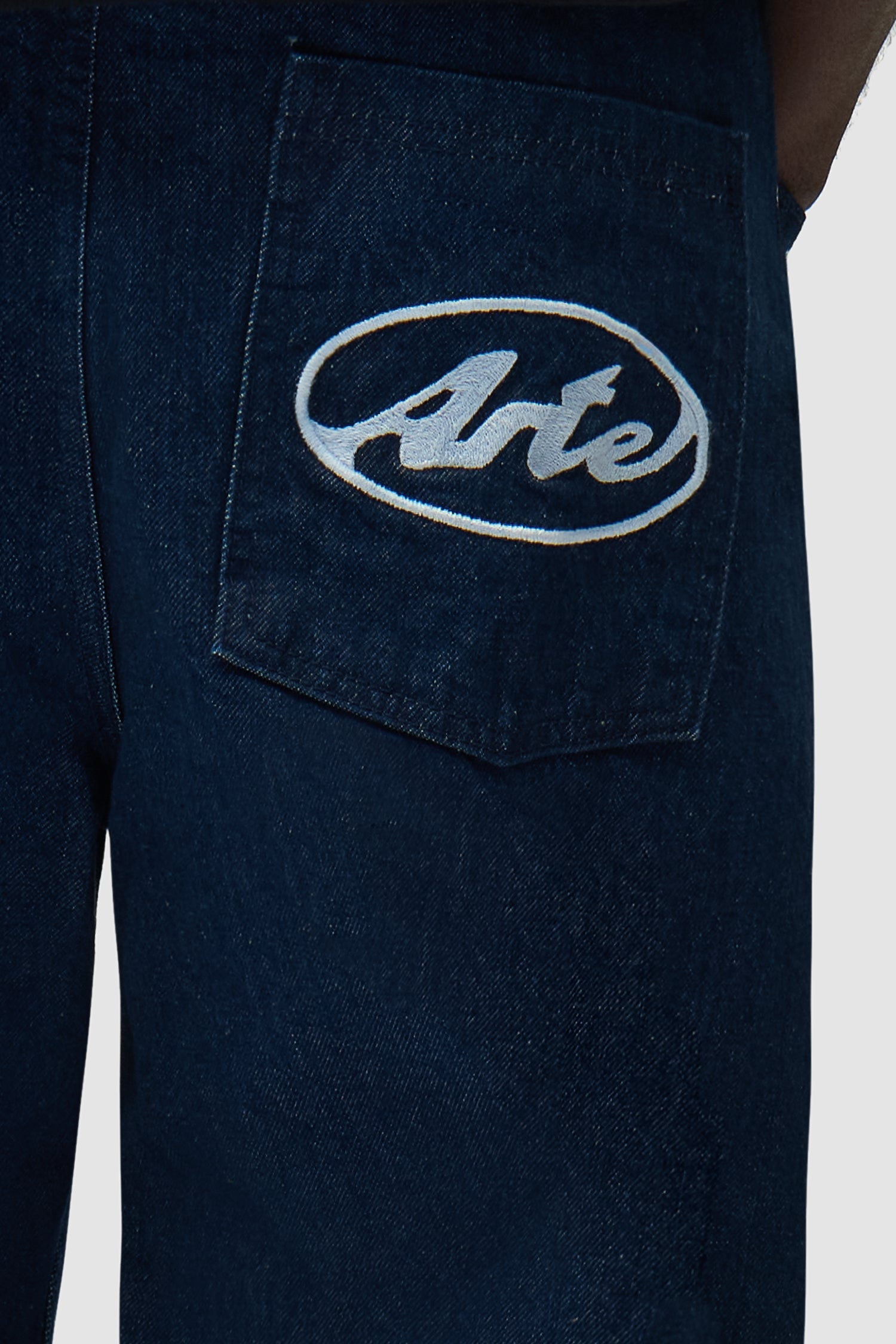 Detail view of Circle Logo Pocket Pants in Raw Denim, showing back logo