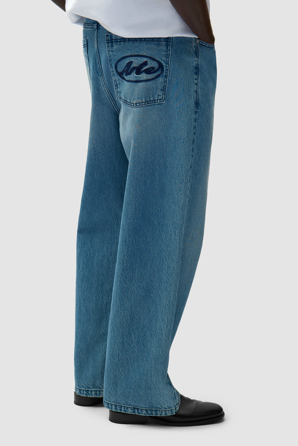 Circle Logo Pocket Pants in Denim Bleach worn by a model, half-body side view