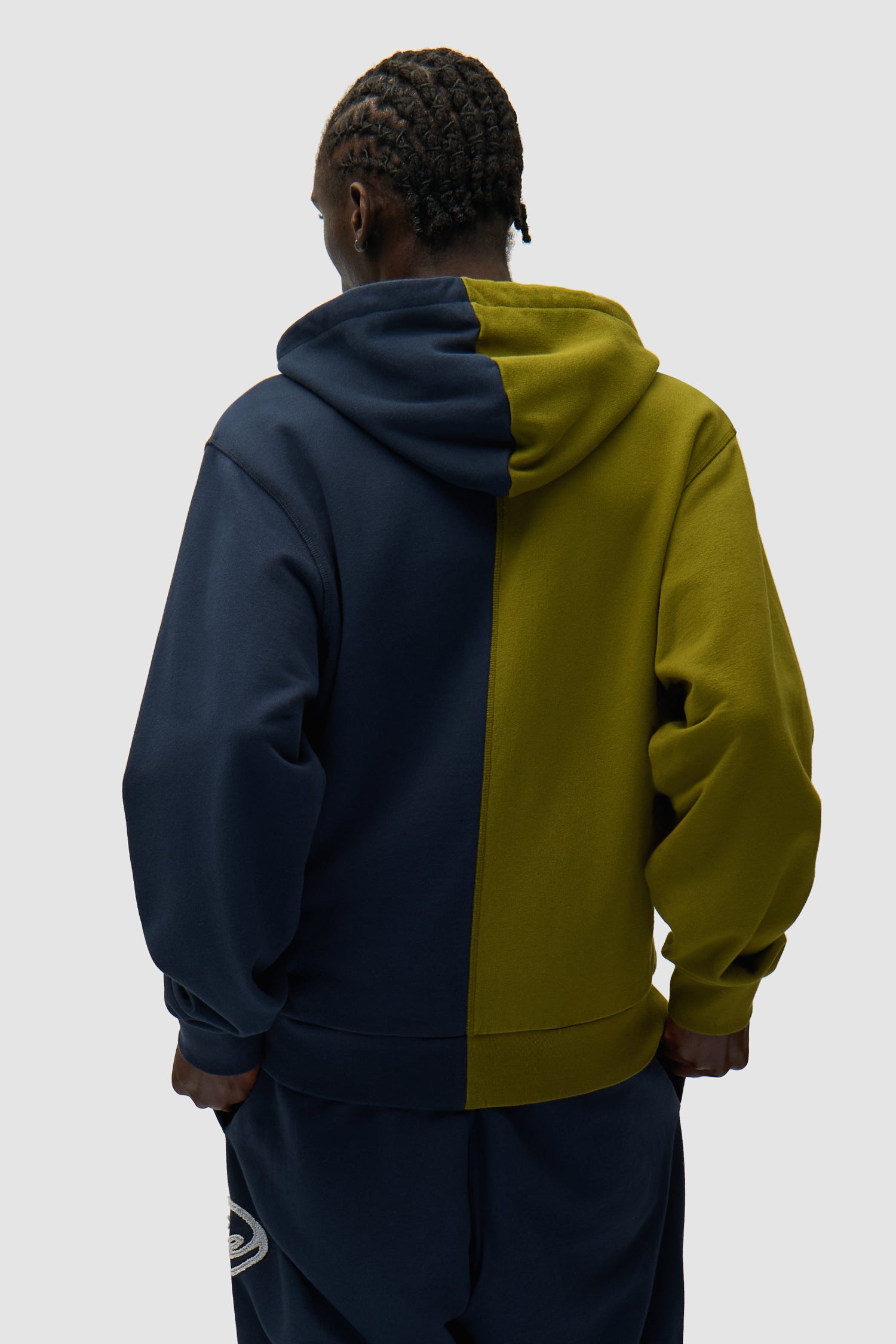 Split Patch Zip Hoodie in Green/Navy worn by a model, half-body back view