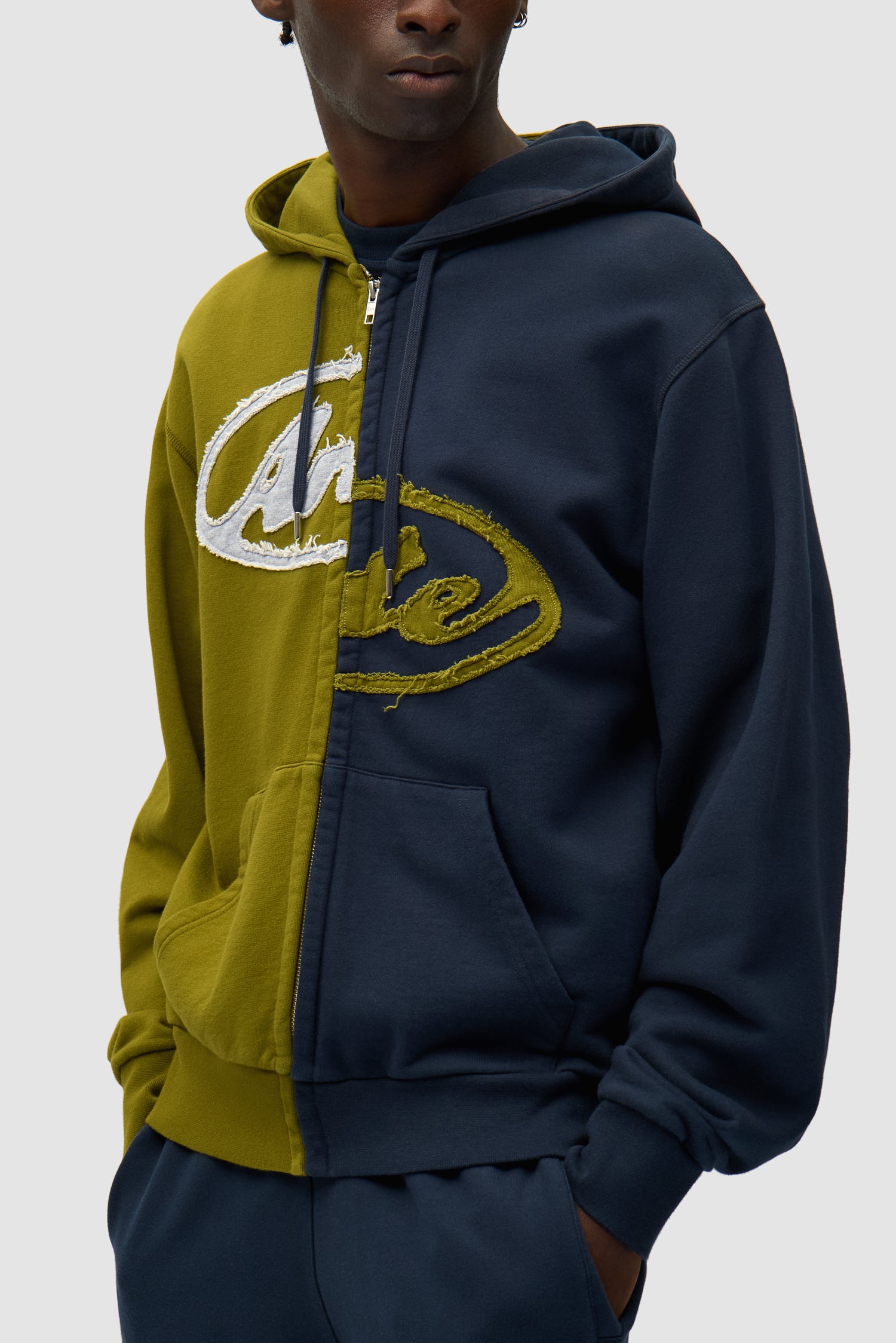 Split Patch Zip Hoodie in Green/Navy worn by a model, half-body detailed view