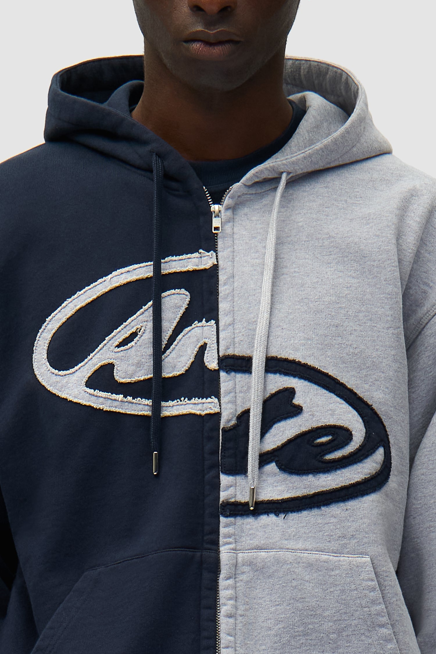 Detail view of Split Patch Zip Hoodie in Grey/Navy, showing front logo