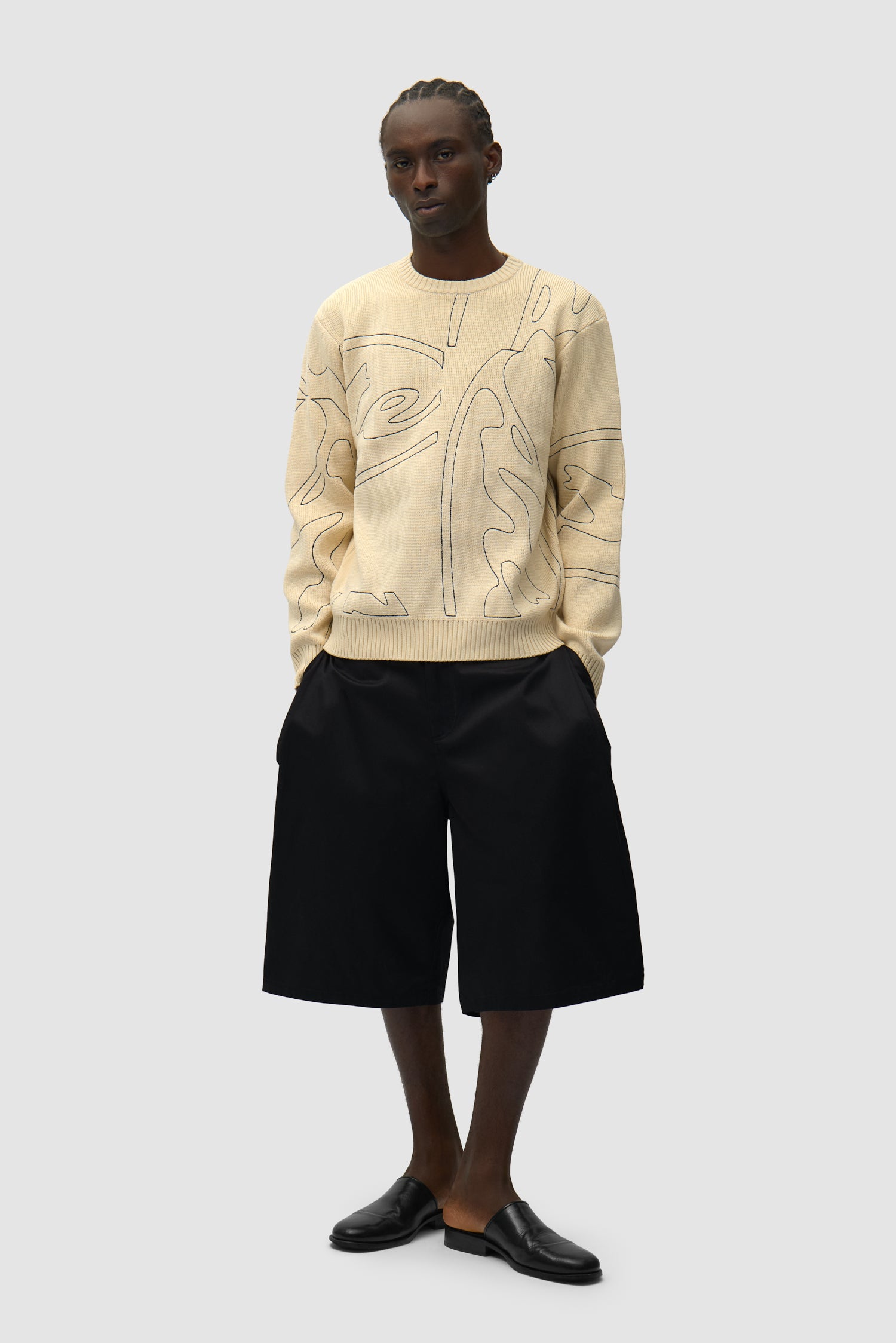 Allover Circle Logo Knit in Cream worn by a model, full-body front view