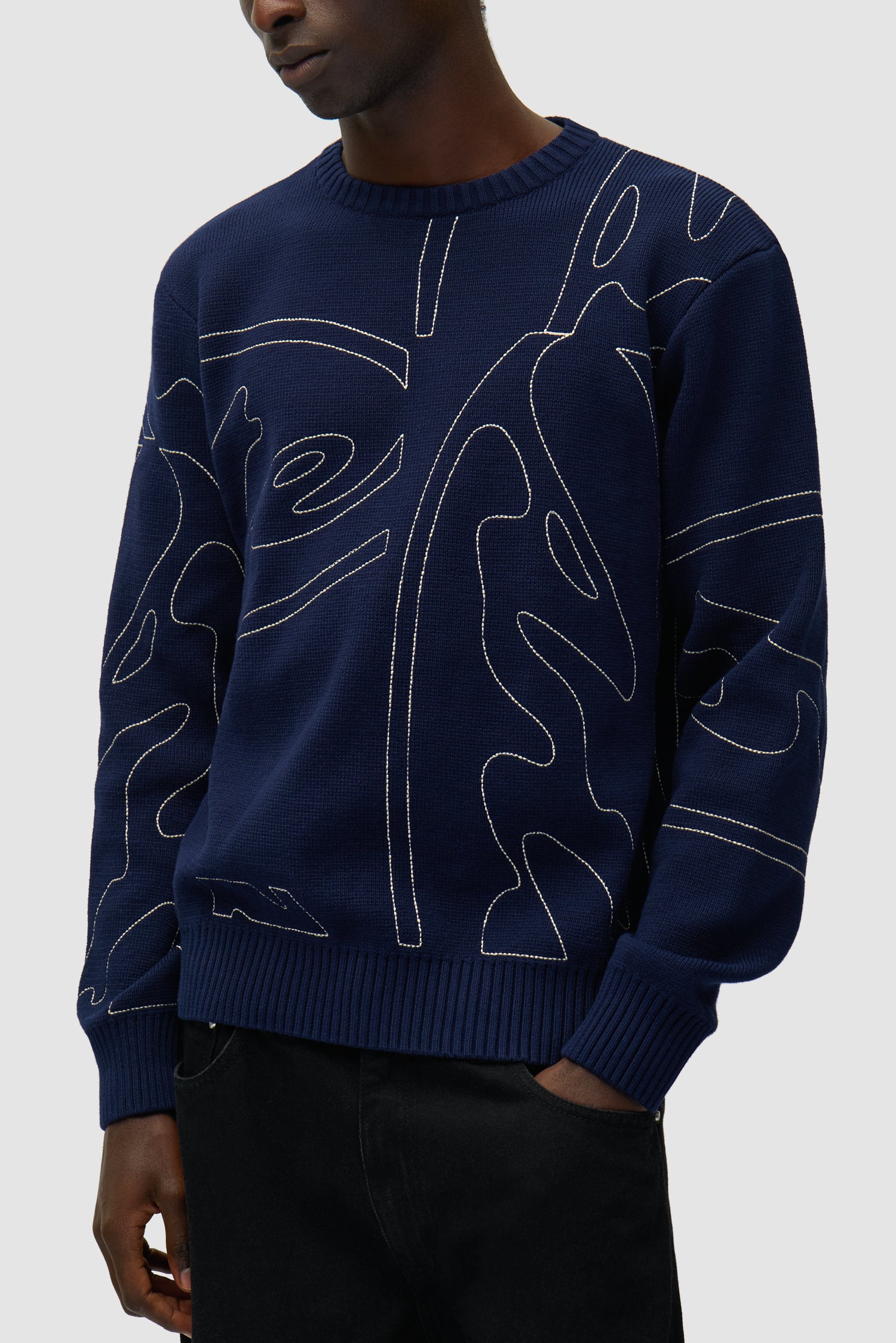Allover Circle Logo Knit in Navy worn by a model, half-body detailed view