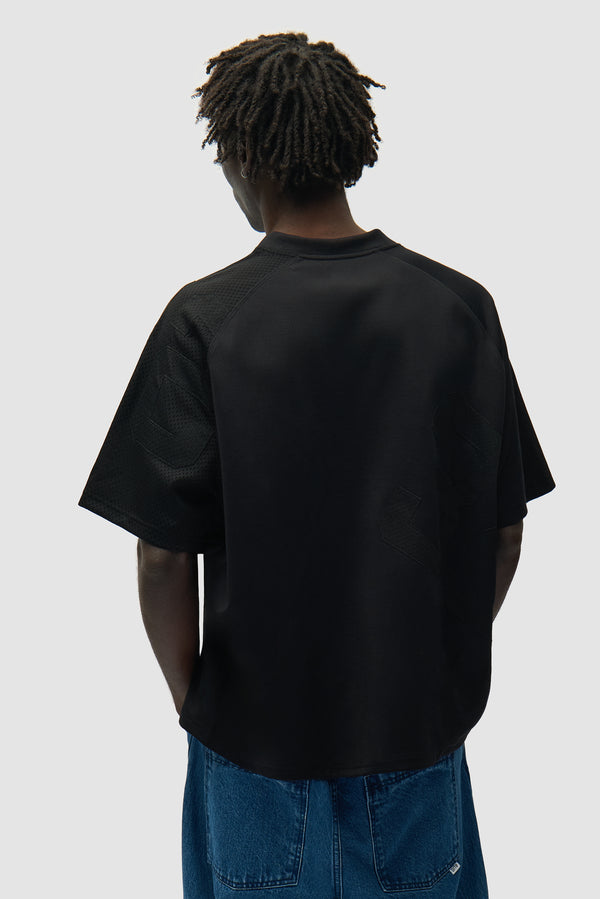 32 Jersey in Black worn by a model, half-body back view