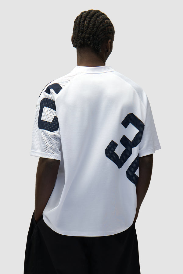 32 Jersey in Navy/White worn by a model, half-body back view
