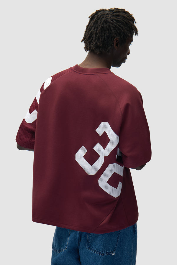 32 Jersey in White/Bordeaux worn by a model, half-body back view