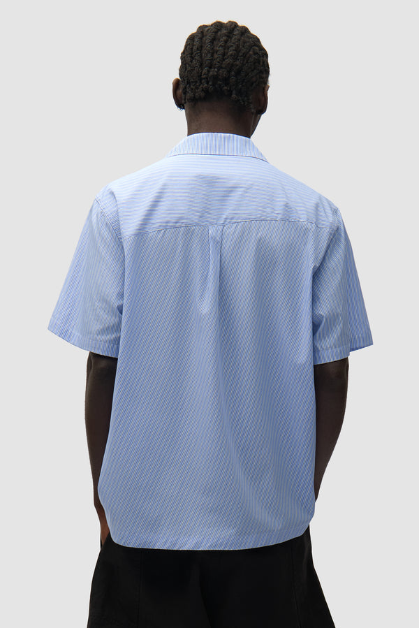 Fold Pocket Shirt in Striped worn by a model, half-body back view
