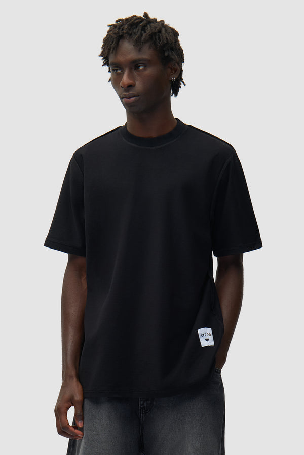 Reversible label T-shirt in Black worn by a model, half-body front view