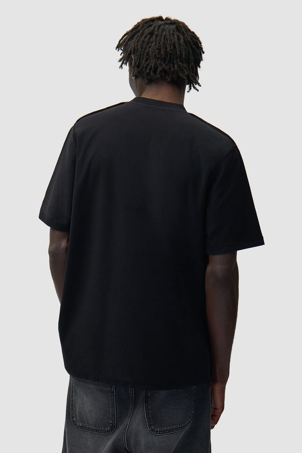 Reversible label T-shirt in Black worn by a model, half-body back view