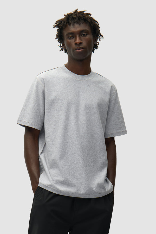 Reversible label T-shirt in Grey worn by a model, half-body front view
