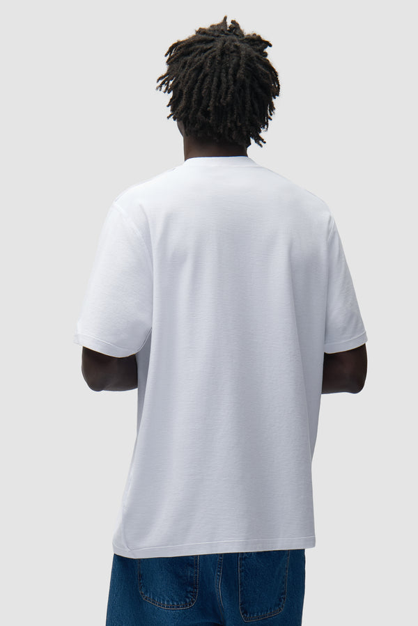 Reversible label T-shirt in White worn by a model, half-body back view