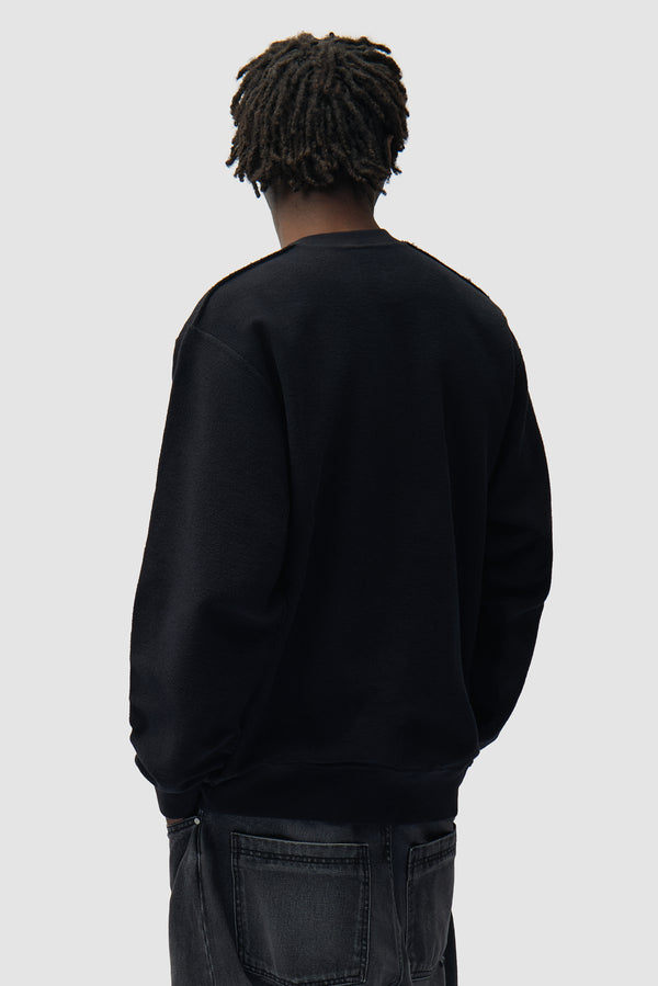 Reversible label Crewneck in Black worn by a model, half-body back view