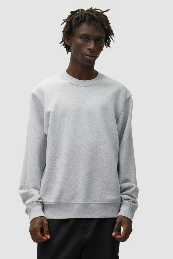 Reversible label Crewneck in Grey worn by a model, half-body front view