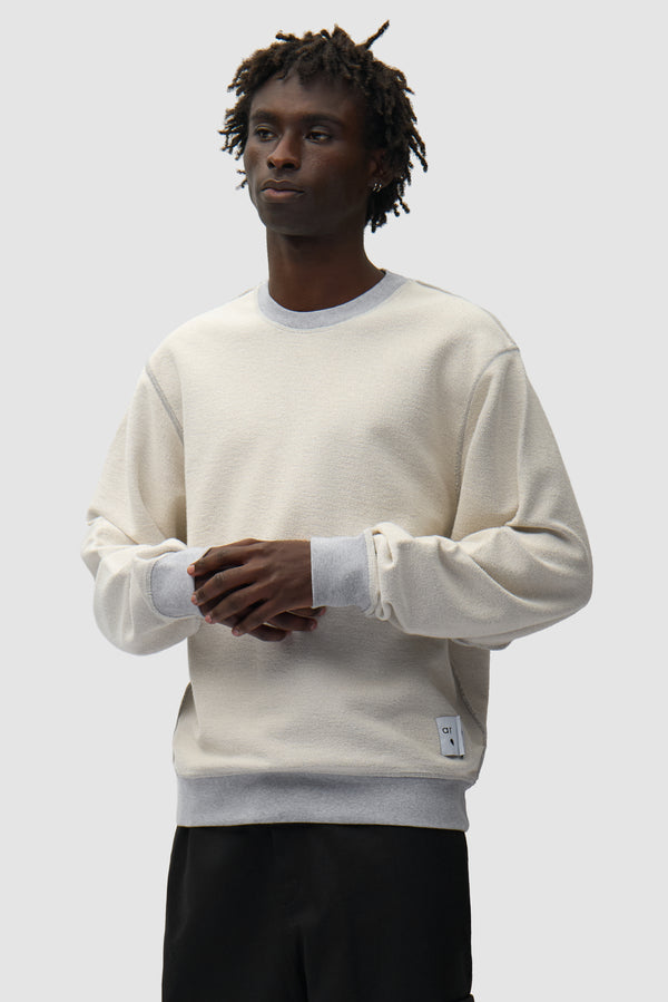 Reversible label Crewneck in Grey Reversed worn by a model, half-body front view