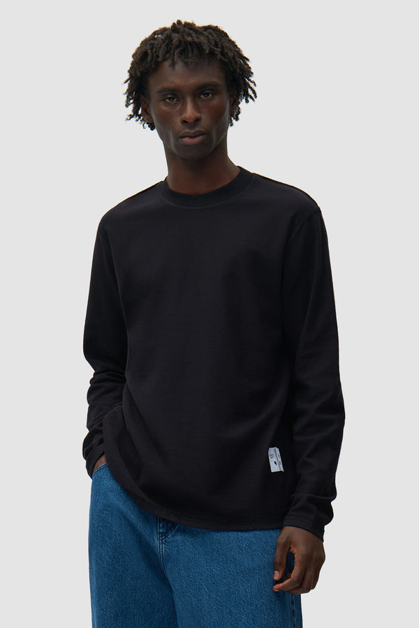 Reversible label Longsleeve in Black worn by a model, half-body front view