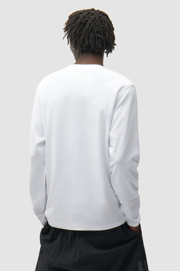 Reversible label Longsleeve in White worn by a model, half-body back view