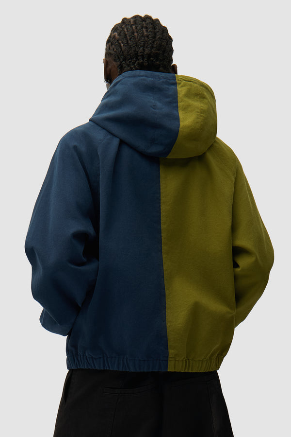Split Logo canvas Hood Jacket in Navy/Green worn by a model, half-body back view