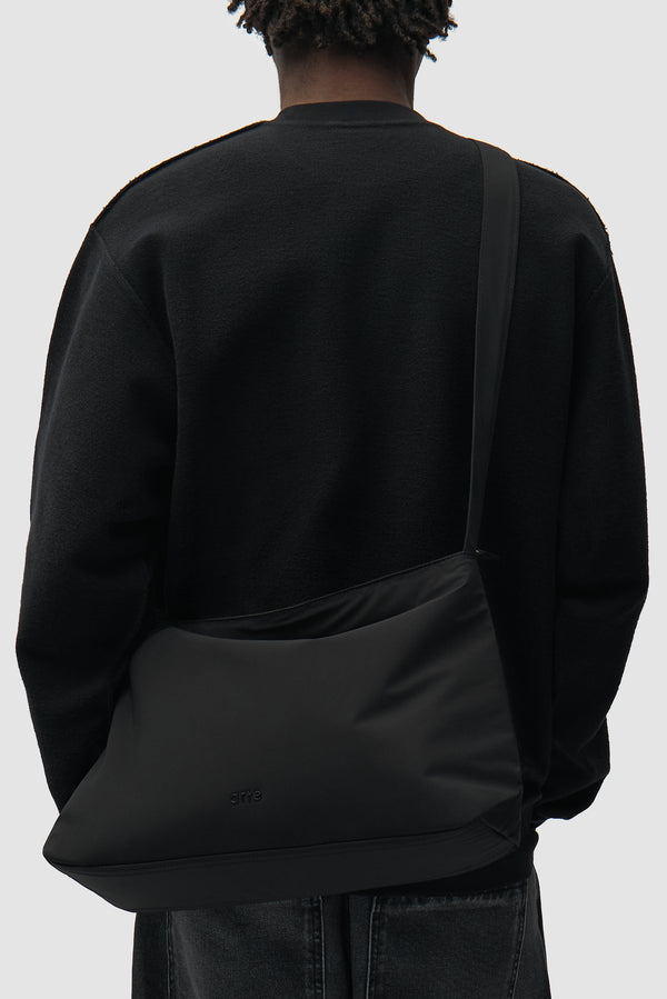 Nylon Bag in Black worn by a model, half-body view