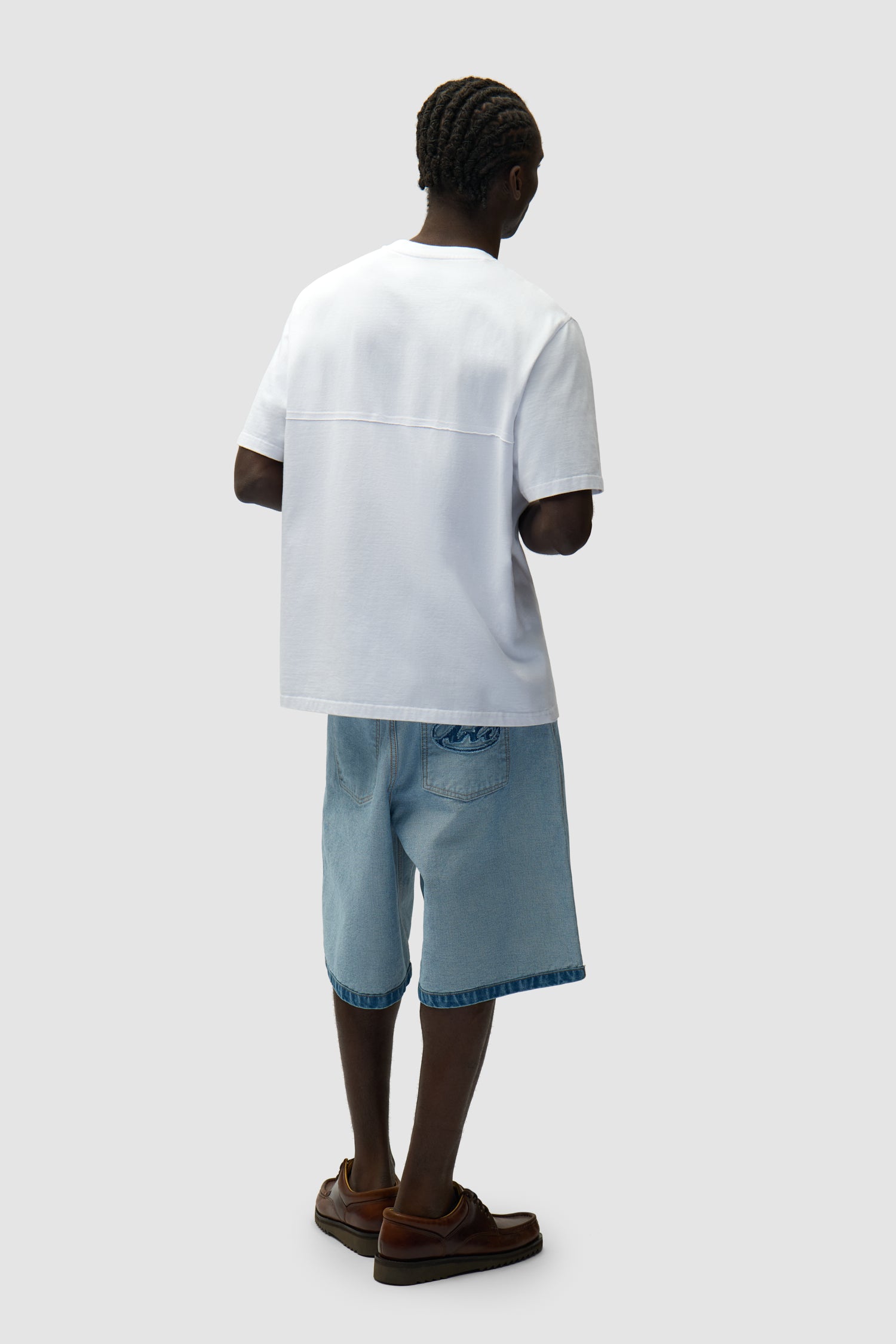 Circle Logo Cut T-shirt in White worn by a model, full-body back view
