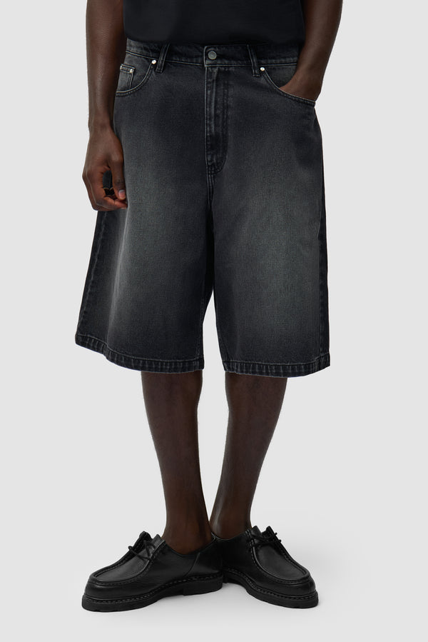 Round pocket Denim Short in Fade Black worn by a model, half-body front view