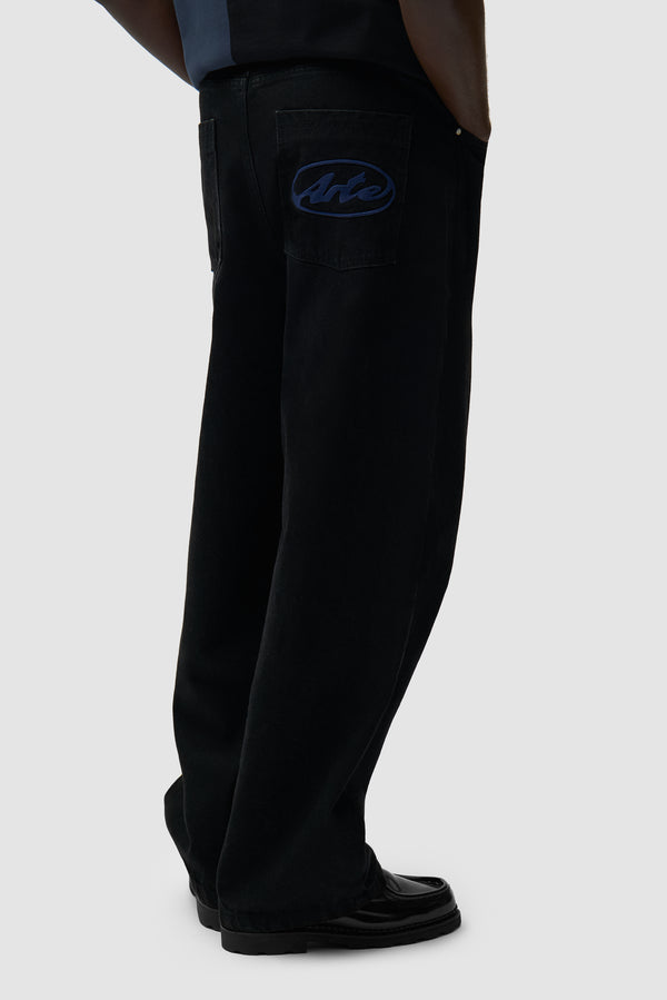 Circle Logo Pocket Pants in Black worn by a model, half-body back view