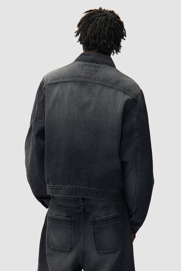 Fold Pocket Denim Jacket in Fade Black worn by a model, half-body back view