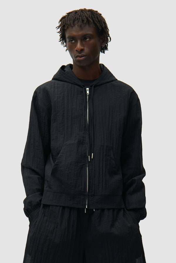 Mesh Jacket in Black worn by a model, half-body front view
