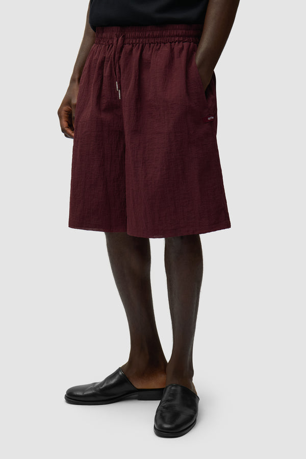 Mesh Shorts in Bordeaux worn by a model, half-body front view