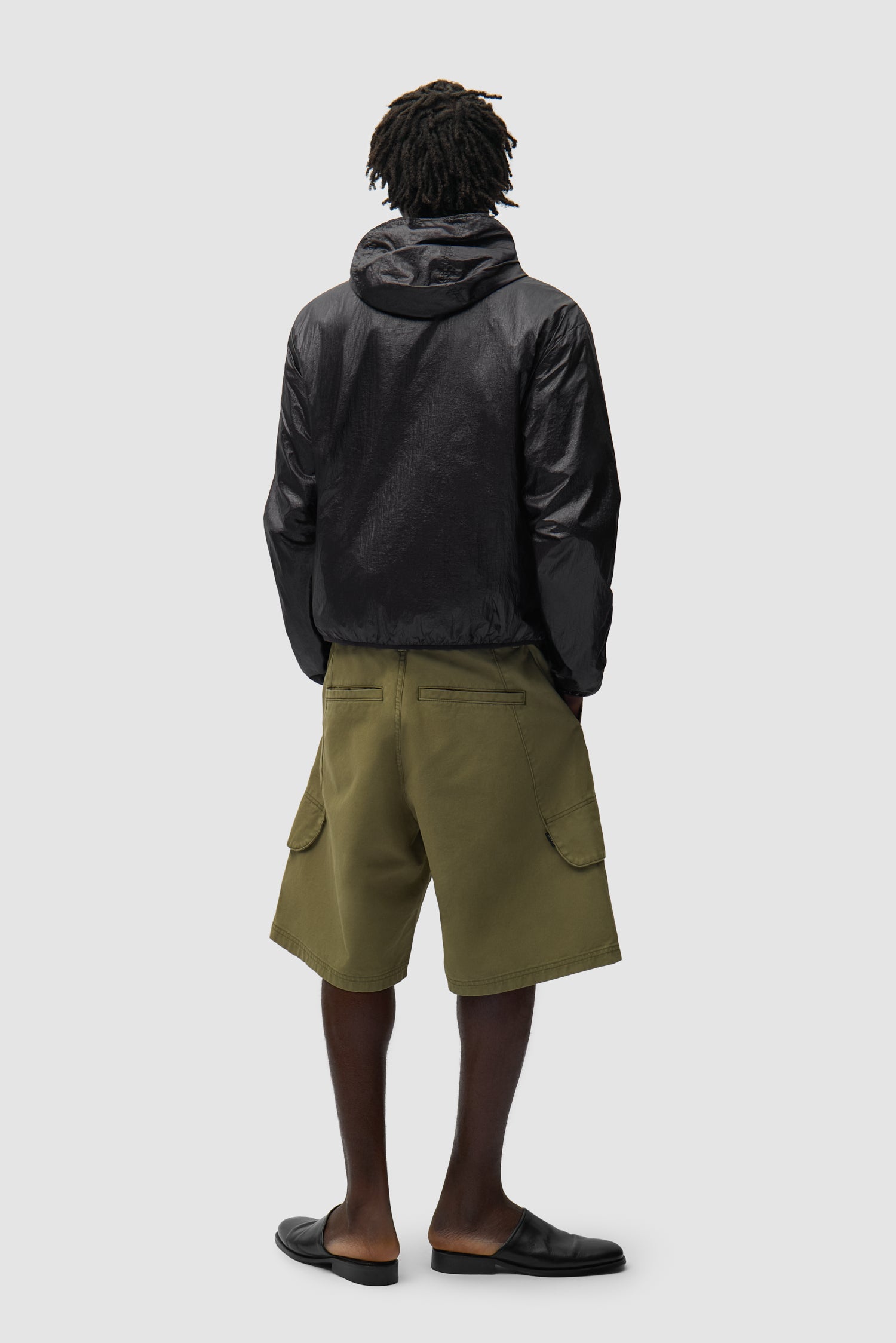 Shiny Nylon Jacket in Black worn by a model, full-body back view