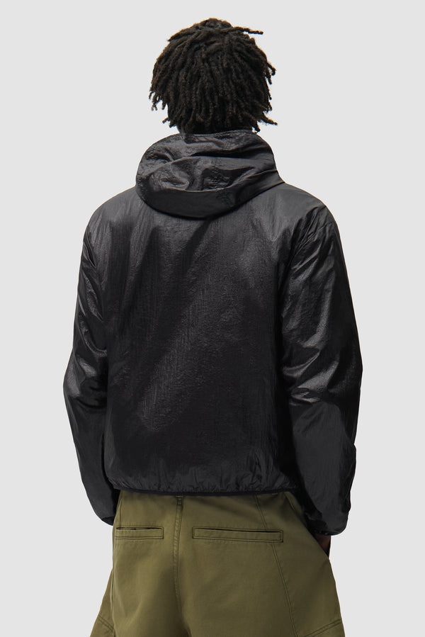 Shiny Nylon Jacket in Black worn by a model, half-body back view