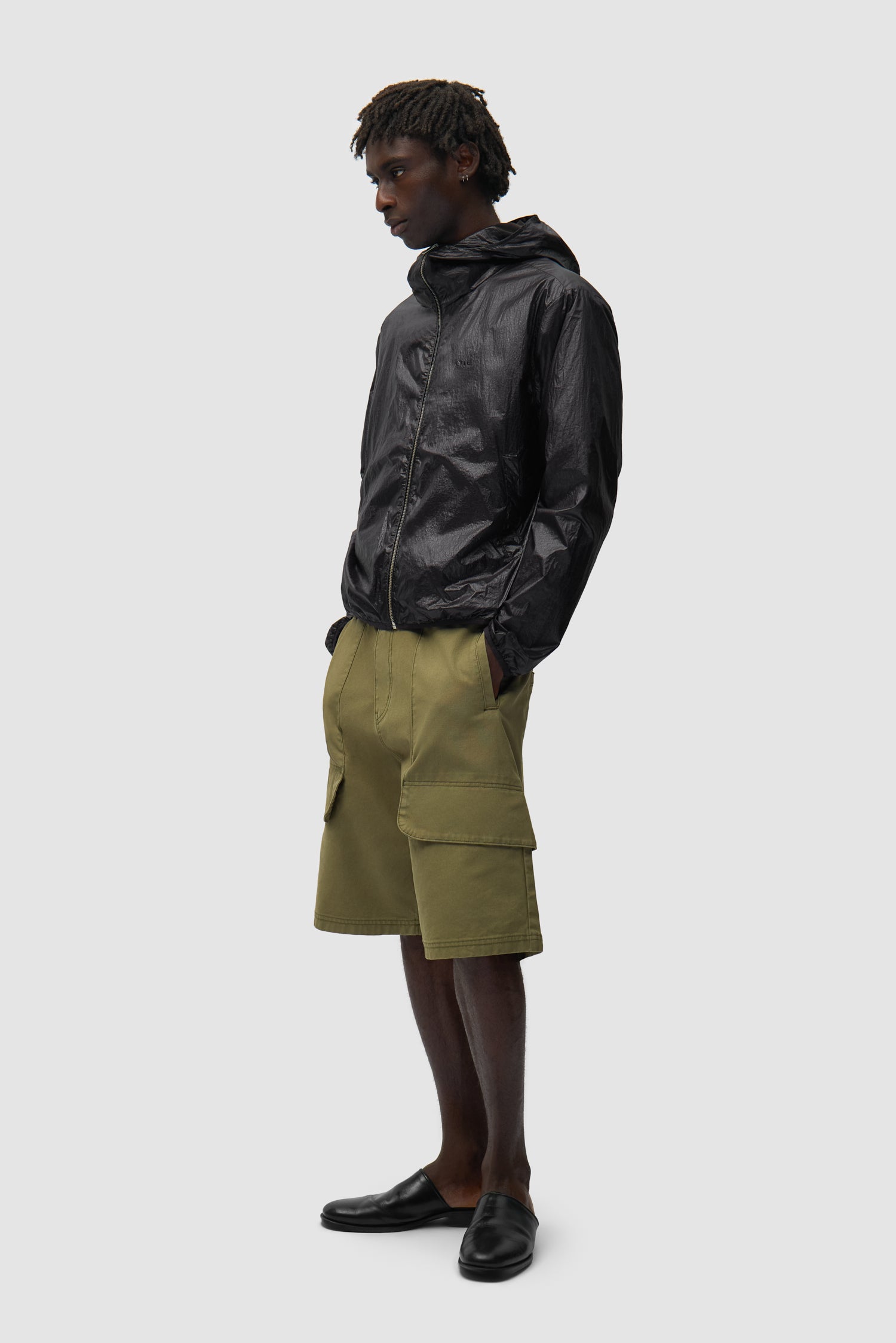 Shiny Nylon Jacket in Black worn by a model, full-body side view