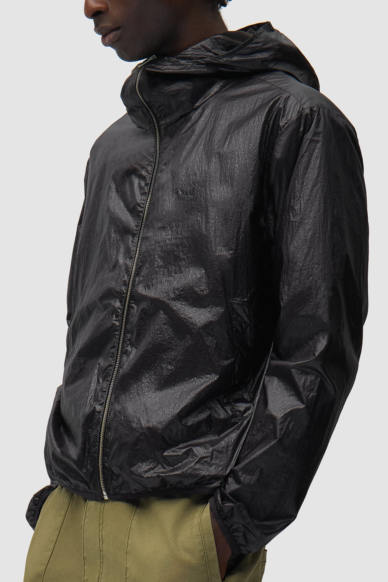 Shiny Nylon Jacket in Black worn by a model, half-body side view
