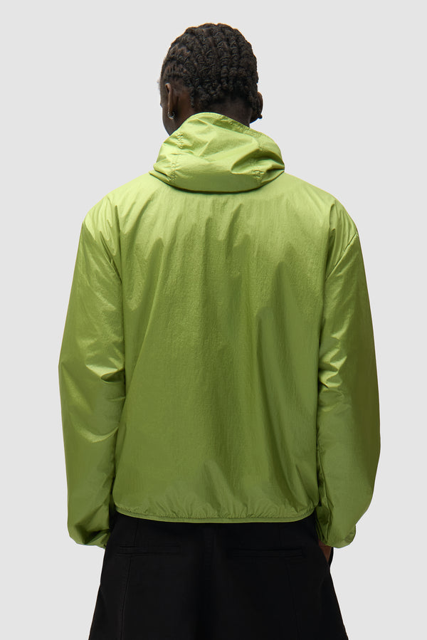 Shiny Nylon Jacket in Green worn by a model, half-body back view