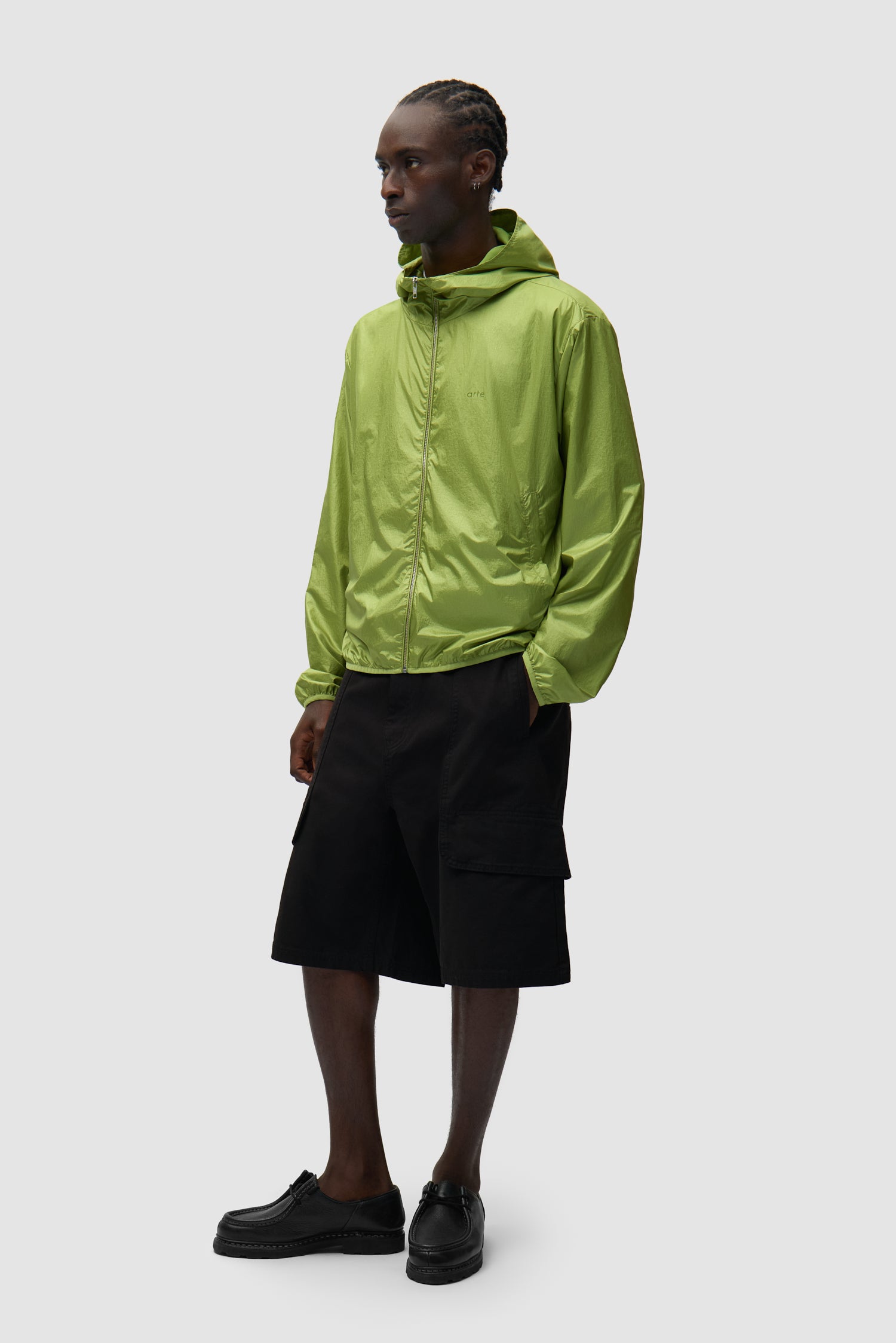 Shiny Nylon Jacket in Green worn by a model, full-body side view