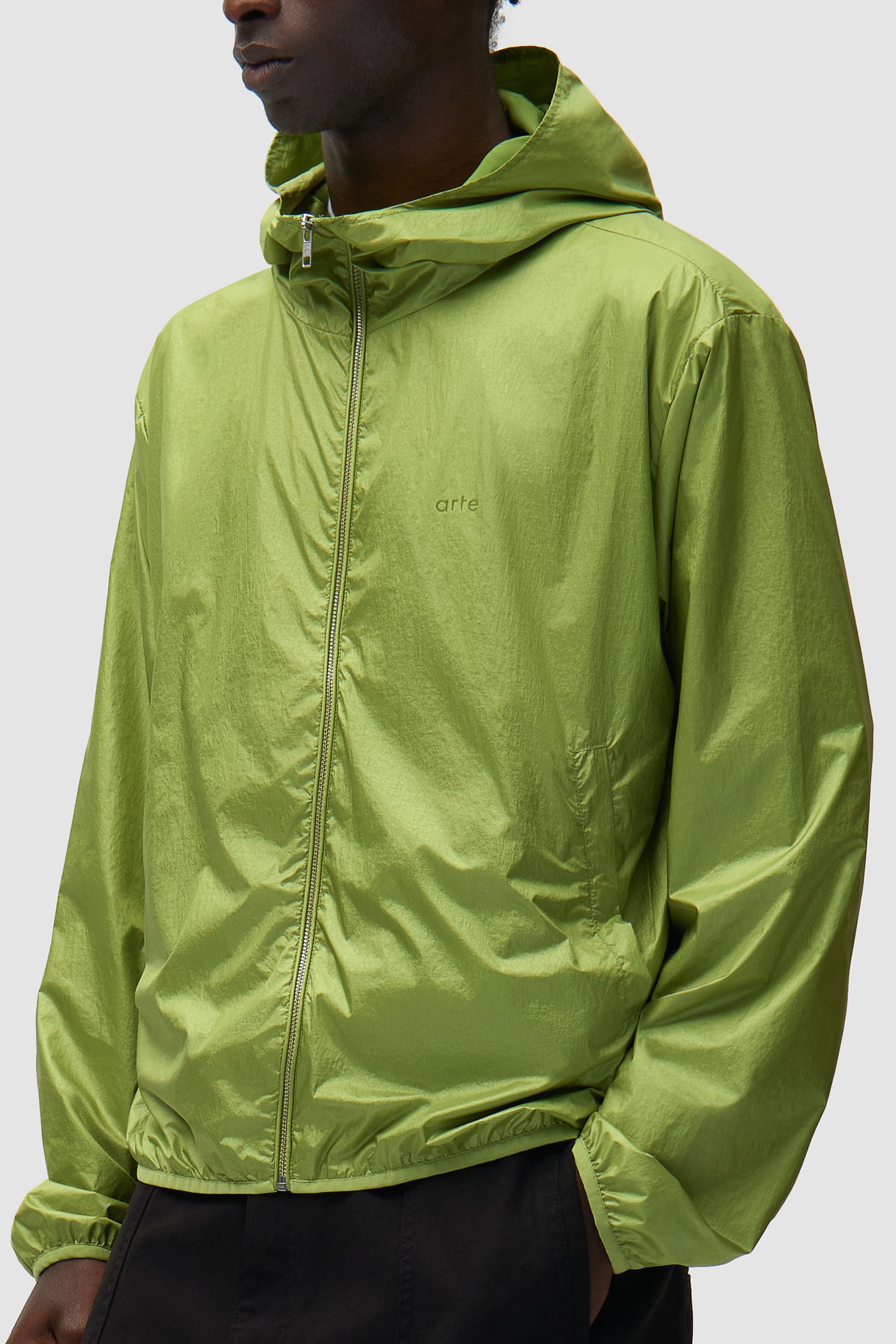 Shiny Nylon Jacket in Green worn by a model, half-body side view