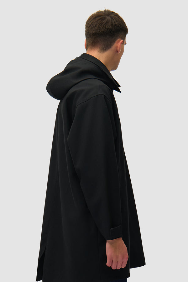 Linen Coat in Black worn by a model, half-body back view