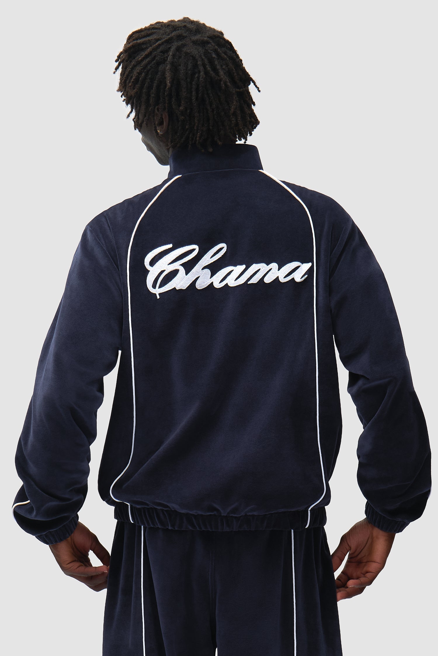 Arte x Poatan Track Jacket in Navy worn by a model, half-body back view
